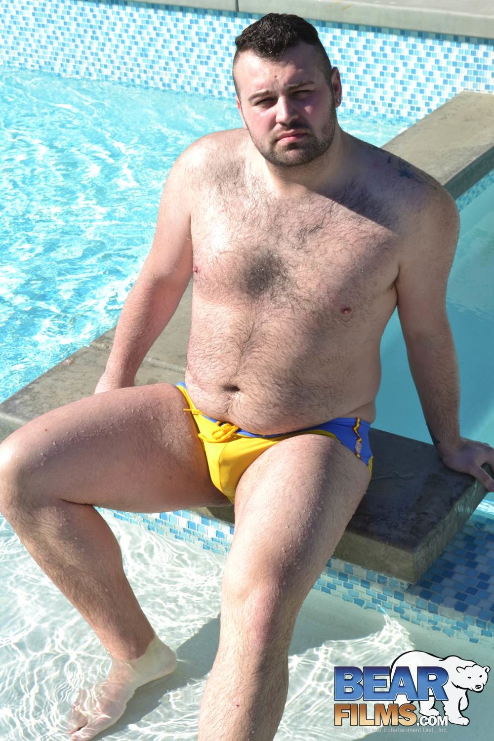 Rex Blue poses in a speedo for gay porn site Bear Films.