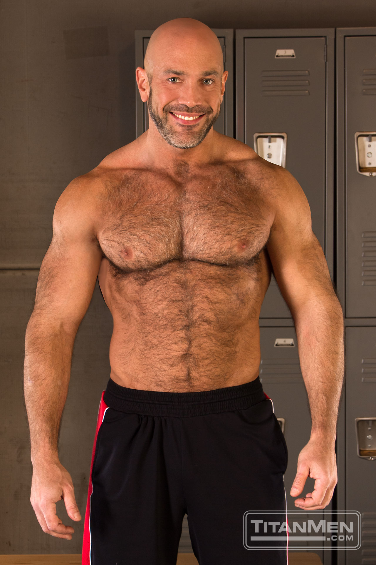 Jesse Jackman bottoms for his real-life partner Dirk Caber in a locker room fuck for the gay porn film Sweat by Titan Men.